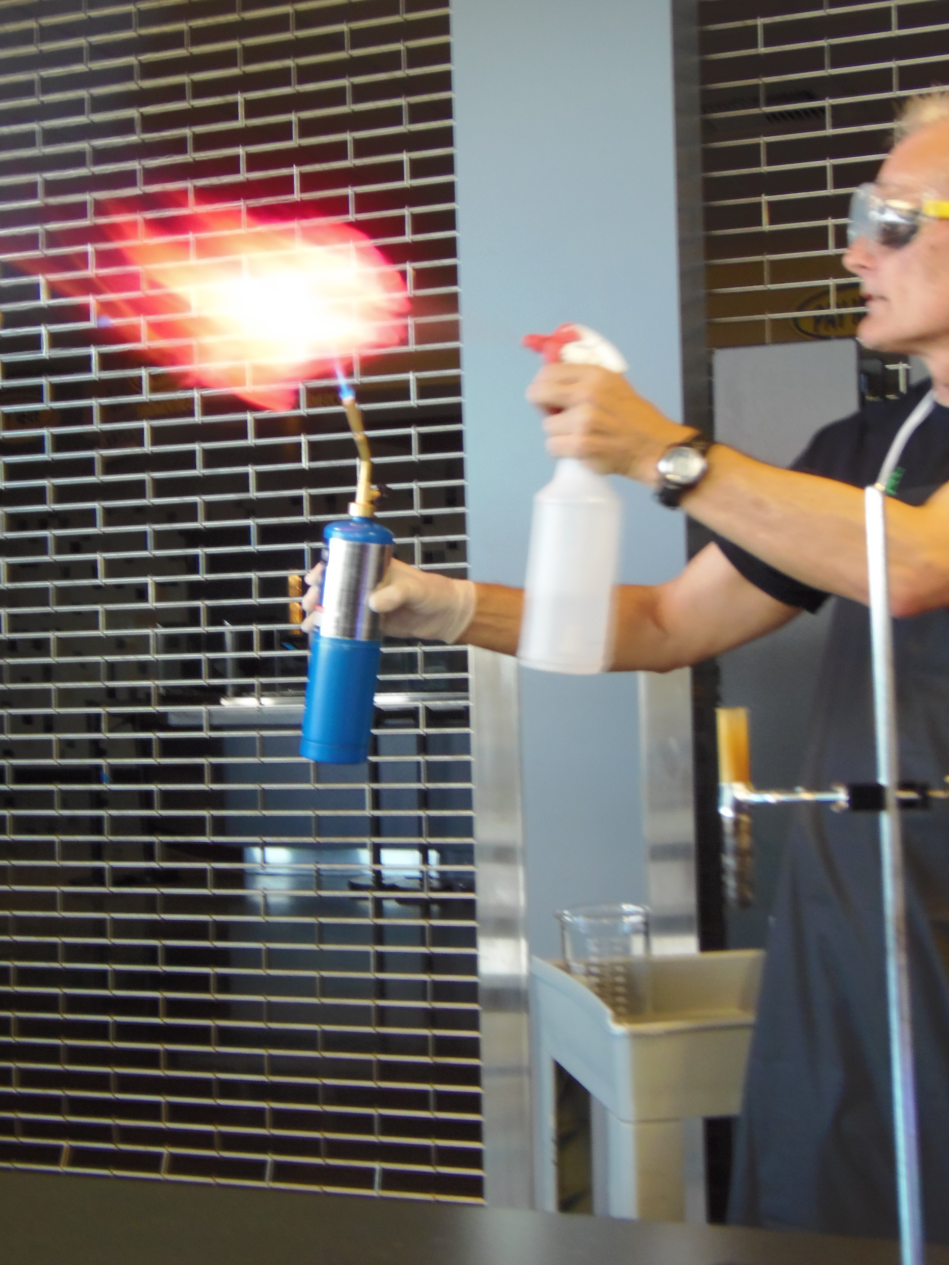 man blowing fire with blowtorch